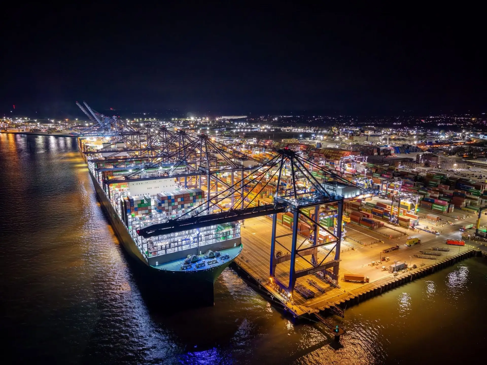 Container ship being loaded at a container port at night